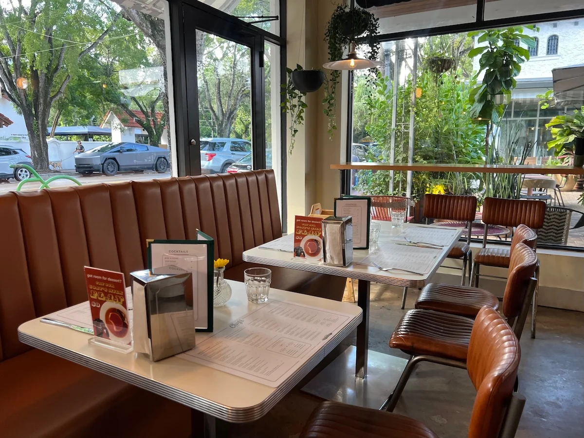 Cafe interior with leather booths and set tables