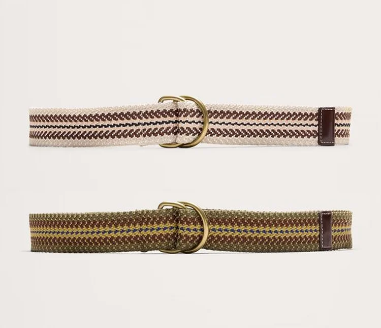 Two woven fabric belts with brass buckles flat-laid